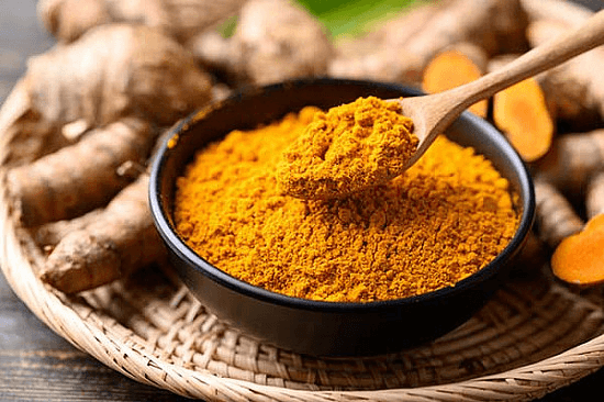 turmeric powder being spooned